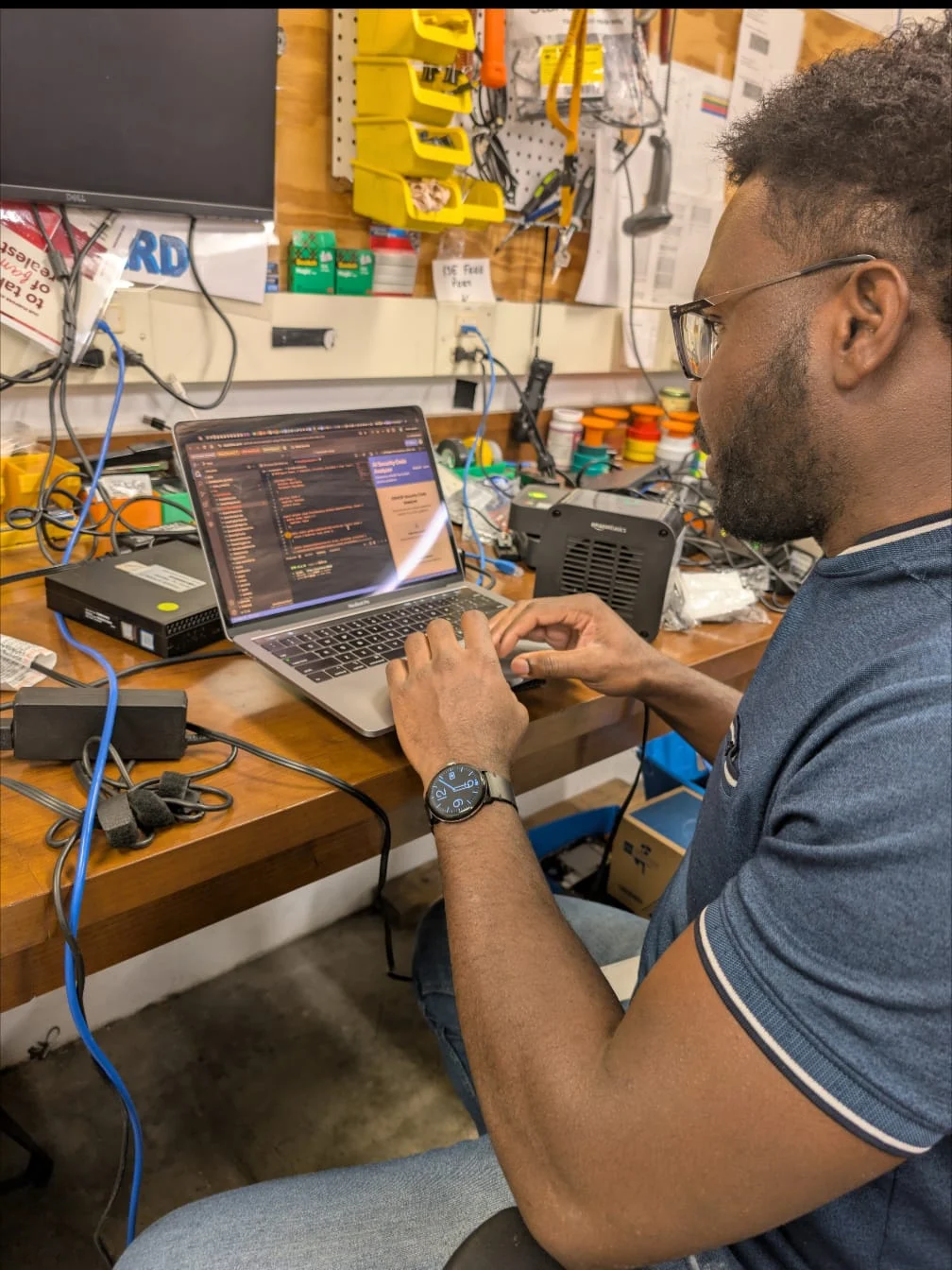 Aiwanfo founder building operational tools in a technical workshop